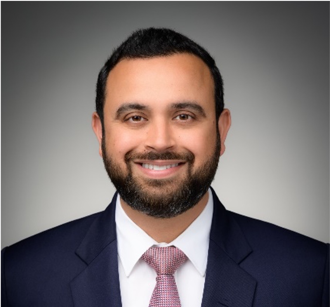 man with beard in suit smiling