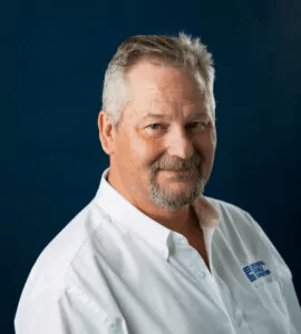 man in white shirt smiling at camera